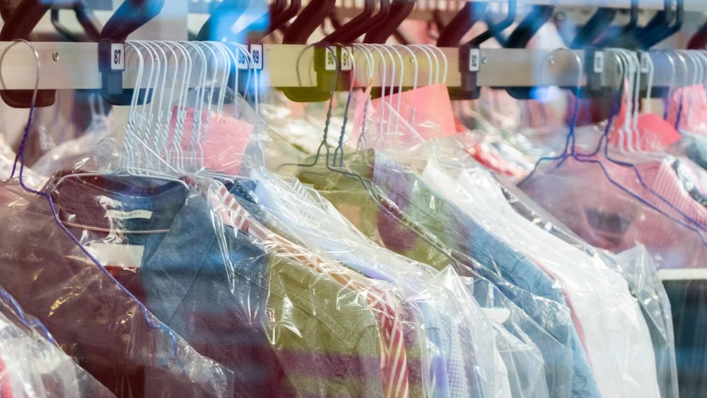 Wire hangers holding dry cleaning.